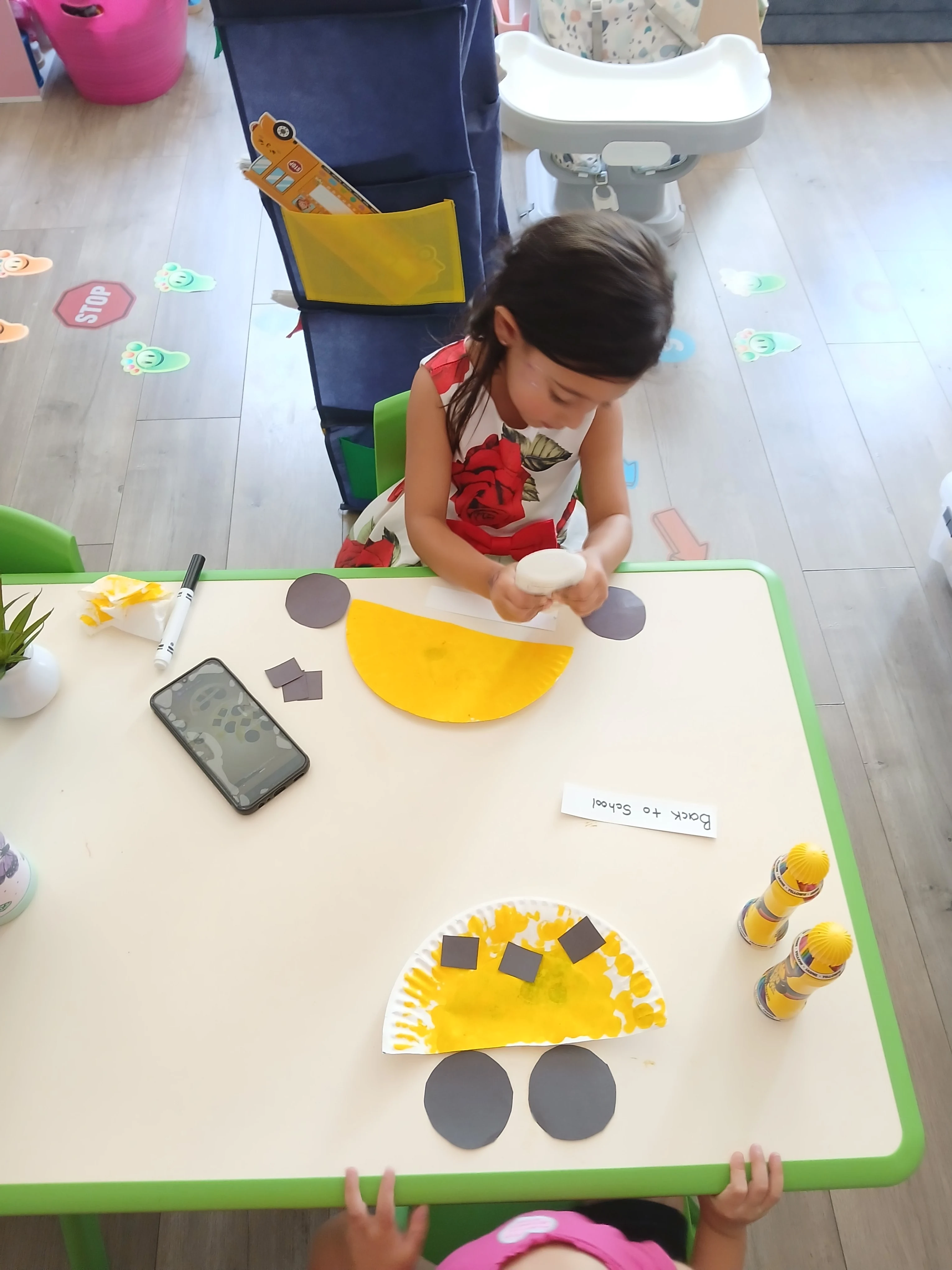 Young child working at a classroom activity table