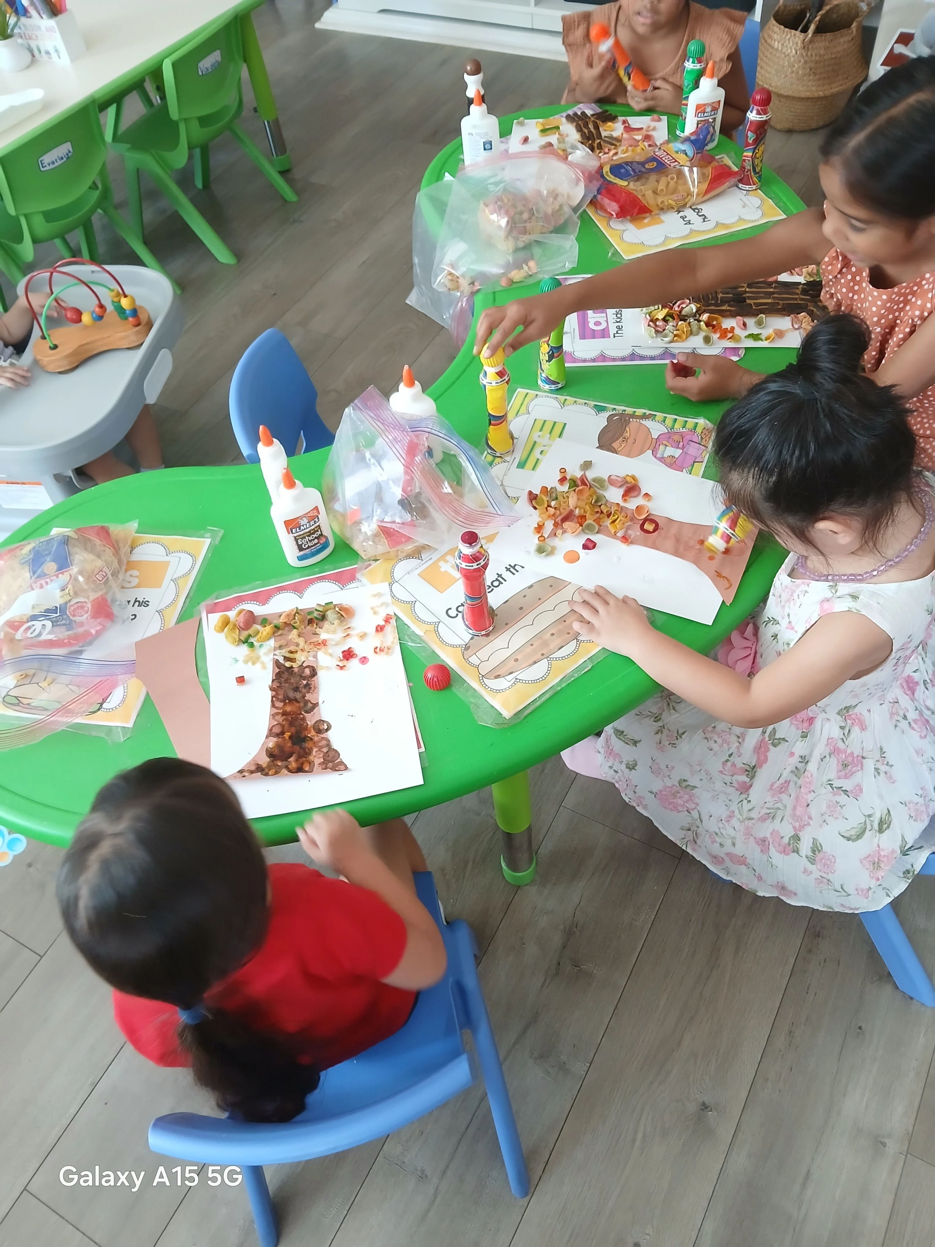 Children creating art together at a classroom table
